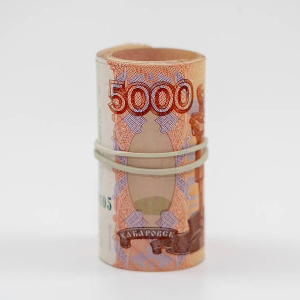 istock Banknotes five thousand rubles 5000 in a roll with an elastic band. Russian currency to save. Close-up, white background. The concept of the safety of deposits and money. 1224135521