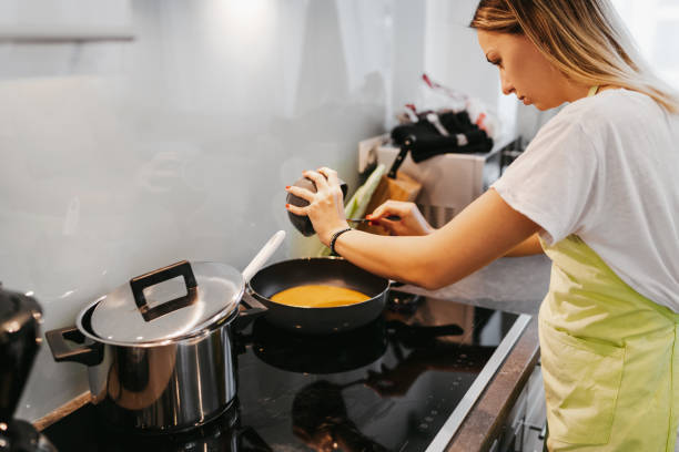 istock Young woman preparing breakfast 1224135776