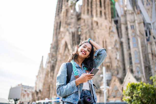istock Relaxed Female Vacationer Using Smart Phone in Barcelona 1224135970