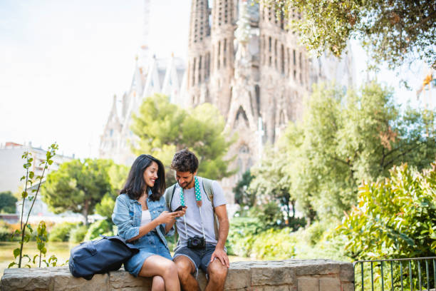 istock Barcelona Sightseers Resting and Checking Smart Phone Photos 1224135976
