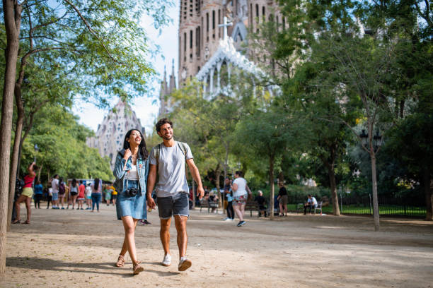 istock Vacationing Couple Walking Through Barcelona Public Park 1224136058