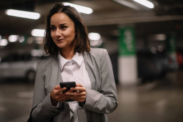 istock Businesswoman in garage using phone. 1224136679