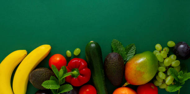 istock Fresh fruits and vegetables over green background, copy space. 1224136689