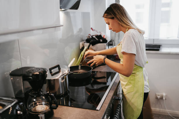 istock Young woman preparing breakfast 1224136792