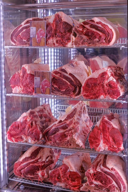 raw dry aged bistecca alla fiorentina, t-bone or porterhouse steak at the entrance of a restaurant in florence, italy - veal t bone steak raw steak imagens e fotografias de stock