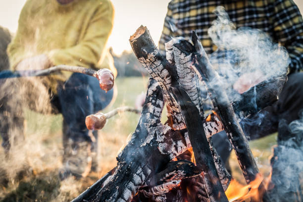 istock Mature couple roasting sausage over campfire 1224137105