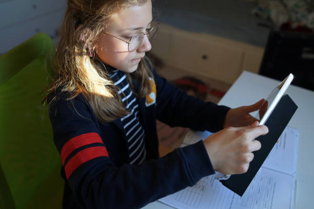 istock Real 10 year old girl is doing homeschooling, learning at home, doing homework 1224137198