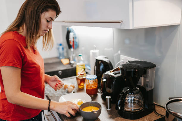 istock Young woman preparing breakfast 1224137297