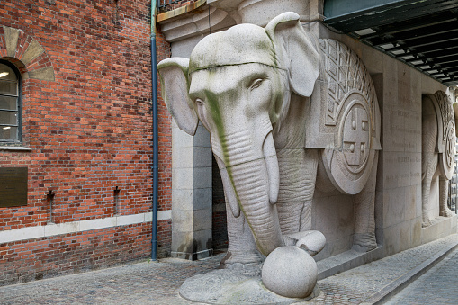 Carlsberg City, Copenhagen, Denmark, April 27, 2020: The Elephant Gate where originally placed inside the Carlsberg brewery, but today it is the center of the new Carlsberg City after the brewery is moved outside Copenhagen. The four elephants where raised to secure a healthy life for the old brewer Jacobsens four surviving children. The elephants are raised in 1901 and are created by Hans Peder Pedersen-Dan.