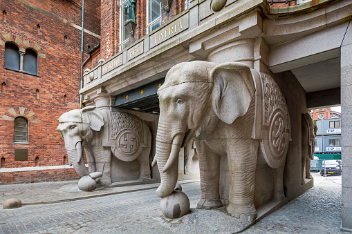 Carlsberg City, Copenhagen, Denmark, April 27, 2020: The Elephant Gate where originally placed inside the Carlsberg brewery, but today it is the center of the new Carlsberg City after the brewery is moved outside Copenhagen. The four elephants where raised to secure a healthy life for the old brewer Jacobsens four surviving children. The elephants are raised in 1901 and are created by Hans Peder Pedersen-Dan.