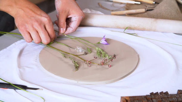 istock ceramic sculptor creates an original drawing on a clay blank 1224137881