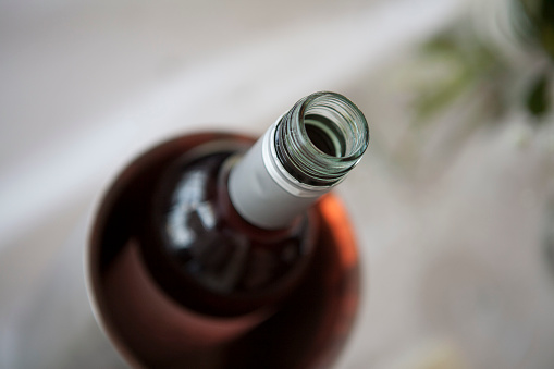 A large heap of empty green wine bottles