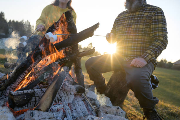 istock Mature couple roasting marshmallows over campfire 1224138598