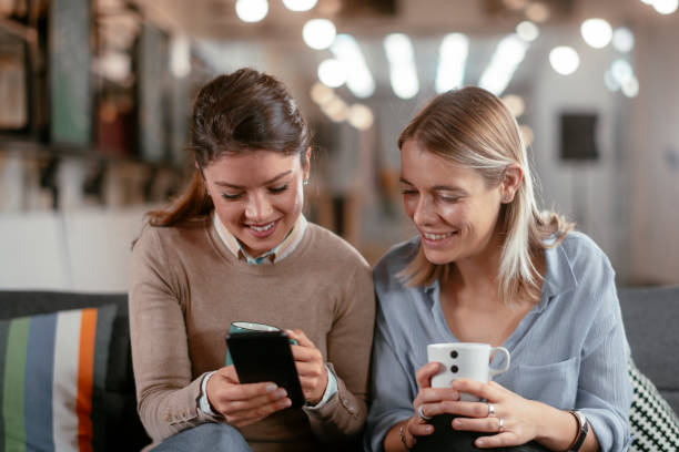 istock Two beautiful girlfriends drinking coffee in office. 1224138679