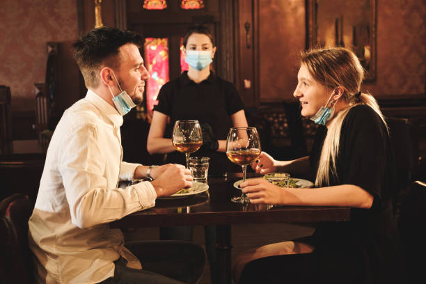 istock Couple eating at bar reopening after quarantine restriction 1224139389