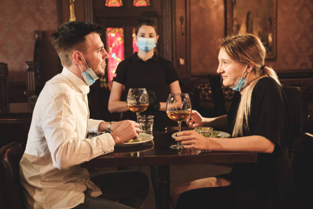 istock Couple eating at bar reopening after quarantine restriction 1224139404
