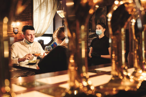 istock Couple eating at bar reopening after quarantine restriction 1224139417