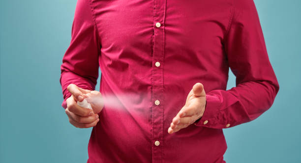 istock Man using spray sanitary for hygiene, close up view. 1224140639