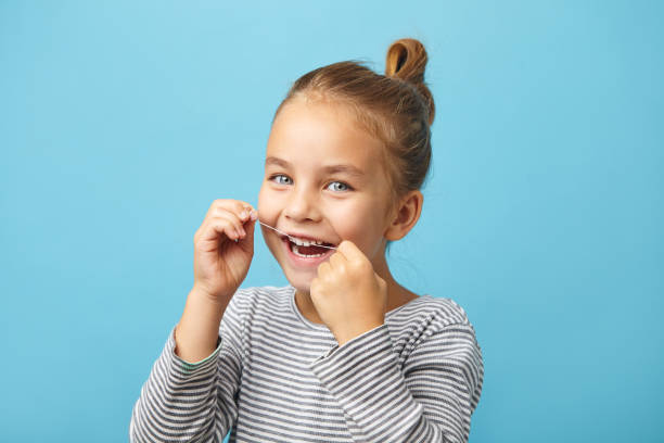 istock Dental flush, caucasian child girl using flossing teeth and smiling 1224141705