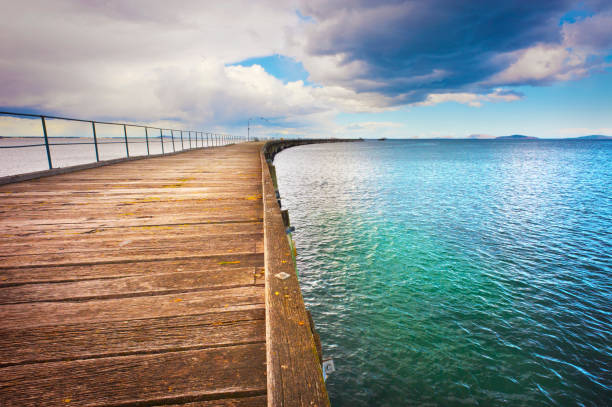istock Long Pier Boardwalk Extends Out Over The Ocean 1224142448