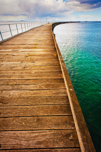 istock Long Pier Boardwalk Extends Out Over The Ocean 1224142536