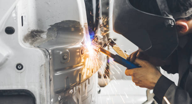 istock Worker welds car. Metalworking with carbon dioxide welding. 1224142685