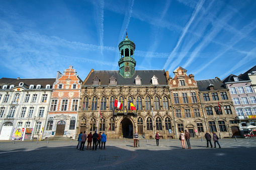 View of the main square of Mons, with the famous City Hall building in the center of the image. This square is one of the liveliest and busiest corners of the Belgian city, which was the European Capital of Culture in 2015.