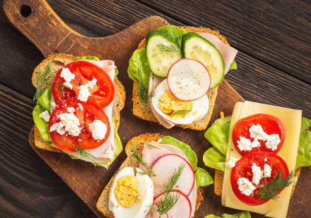 istock Toasts with eggs, cheese, ham, radish, cucumbers and tomatoes , breakfast idea. 1224145267
