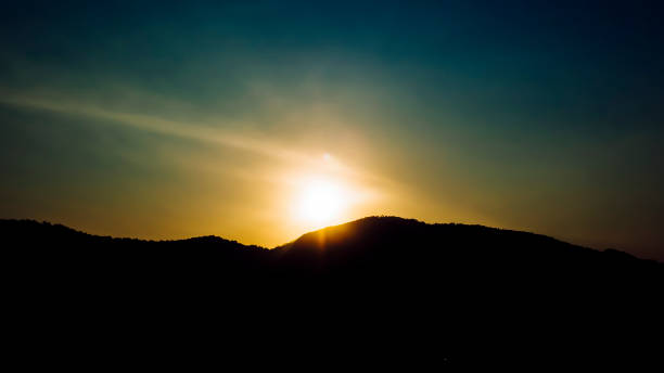 istock Dramatic sunset or sunrise with sun flare over mountain valley beautiful nature background 1224145560