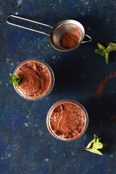 istock Two servings of tiramisu garnished with cocoa and mint 1224146140