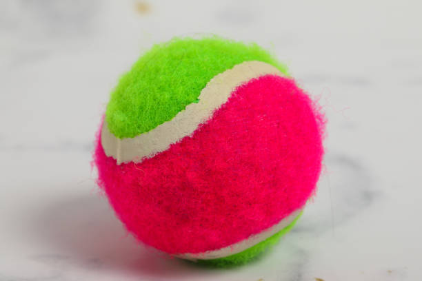 istock green pink red tennis ball on marble background 1224146421
