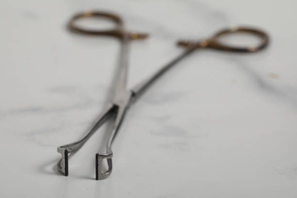 istock surgical metal plier on marble back medical tool 1224146511