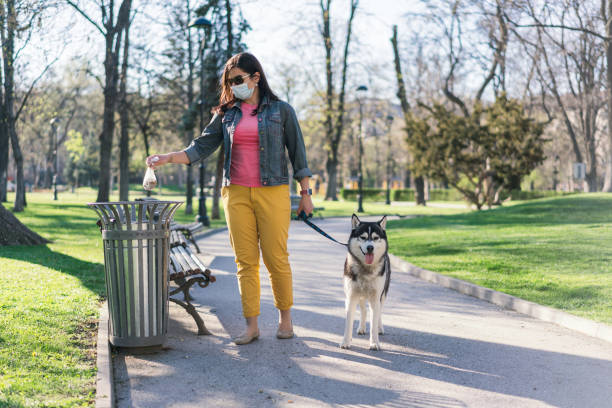 istock Woman walking her dog in empty park during Covid-19 lockdown 1224147527