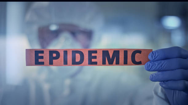 istock Fighting with pandemic concept. Lab worker holding word 'Epidemic' 1224147601