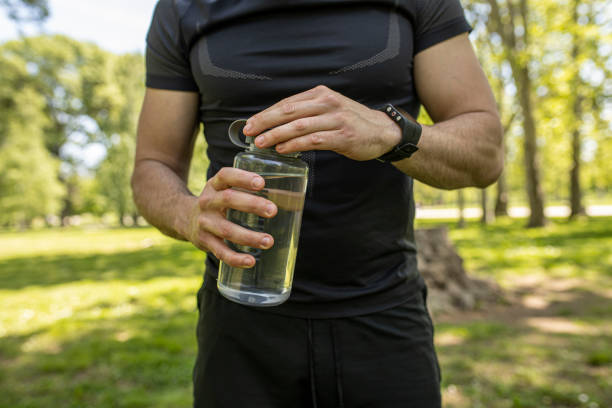istock Man holding a water bottle wearing a smartwatch 1224148157