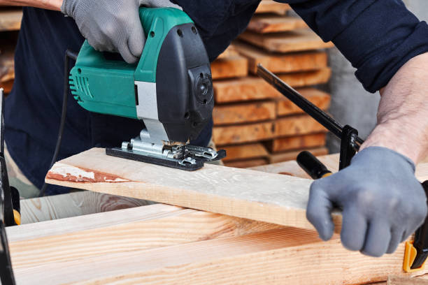 istock Carpenter working with plane on wooden background. Man hand with professional instrument repairing, fixing, building construction 1224148340