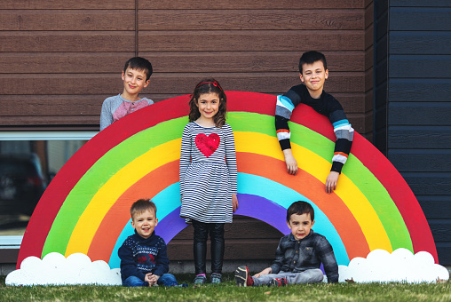 Quarantined family, posing in front of a giant rainbow , Quebec, Canada