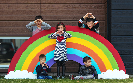 Quarantined family, posing in front of a giant rainbow , Quebec, Canada