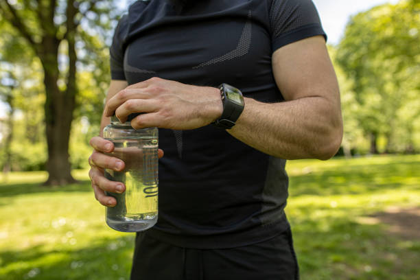 istock Man holding a water bottle wearing a smartwatch 1224149050