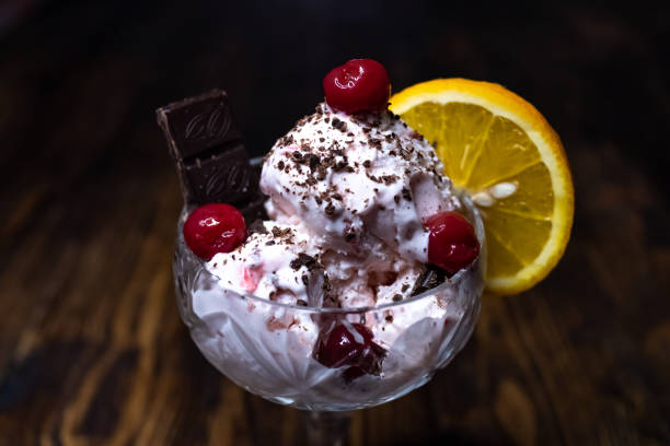 istock Ice cream with chocolate, cherry and orange in a crystal glass 1224149883