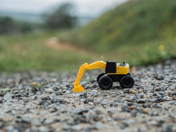 istock Toy construction machinery working on an excavation 1224152100