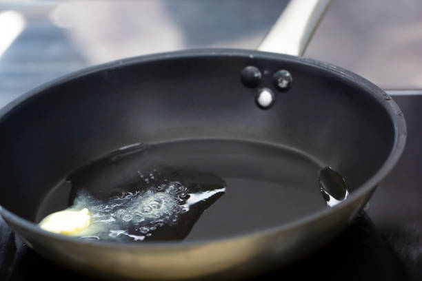 istock piece of butter while melting in frying pan 1224154736