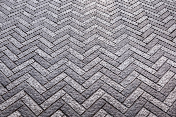 istock Grey paving slabs made of natural stone laid with a herringbone pattern 1224156045
