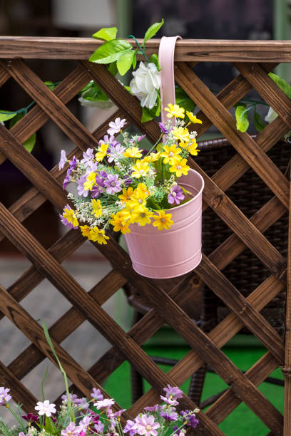 istock colorful flower Pots with fence 1224156175