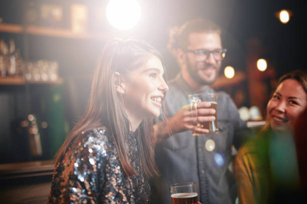 istock Group of friends drinking beer, chatting and having gun at pub. 1224158024