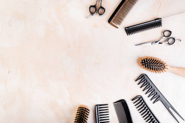 istock Hairdressing instruments. Combs, scissors on beige table top view copy space 1224158041