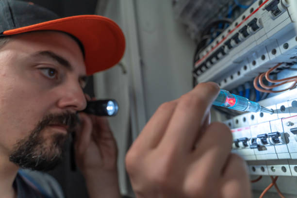 istock Electrician use flashlight to repair fuse box, close-up 1224161109
