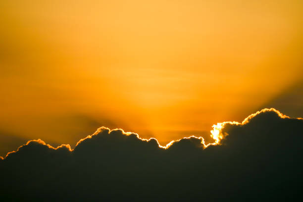 istock sunset sky back on dark silhouette cloud and orange of sun ray last light 1224161753