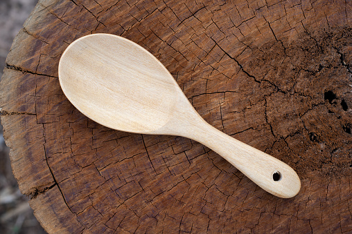 Close up spoon wooden on wood texture in cooking concept.