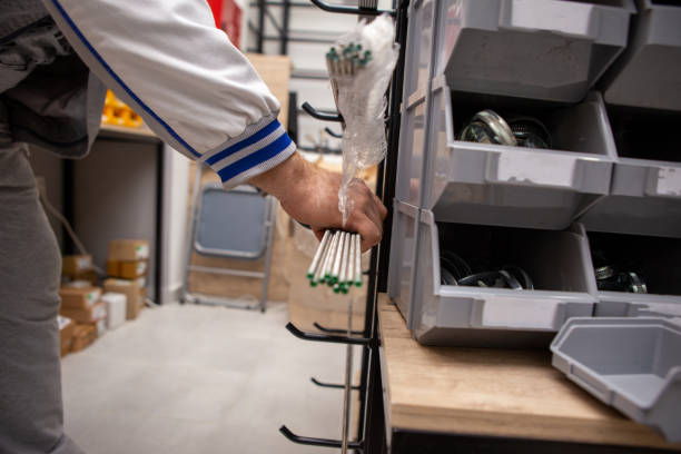 istock Male master worker is touching threaded rods on shelf. It is located in a building materials store 1224164080